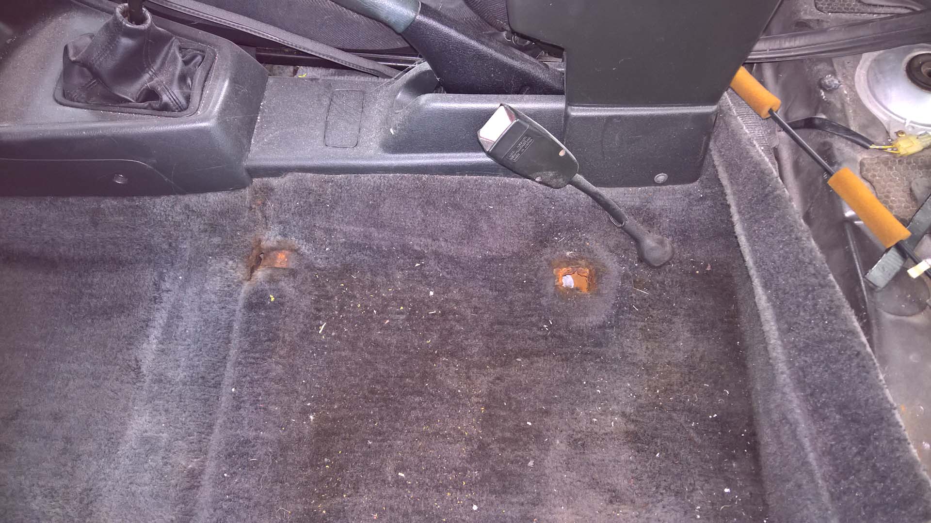 Rusted Seat Anchors on the Floor Pan